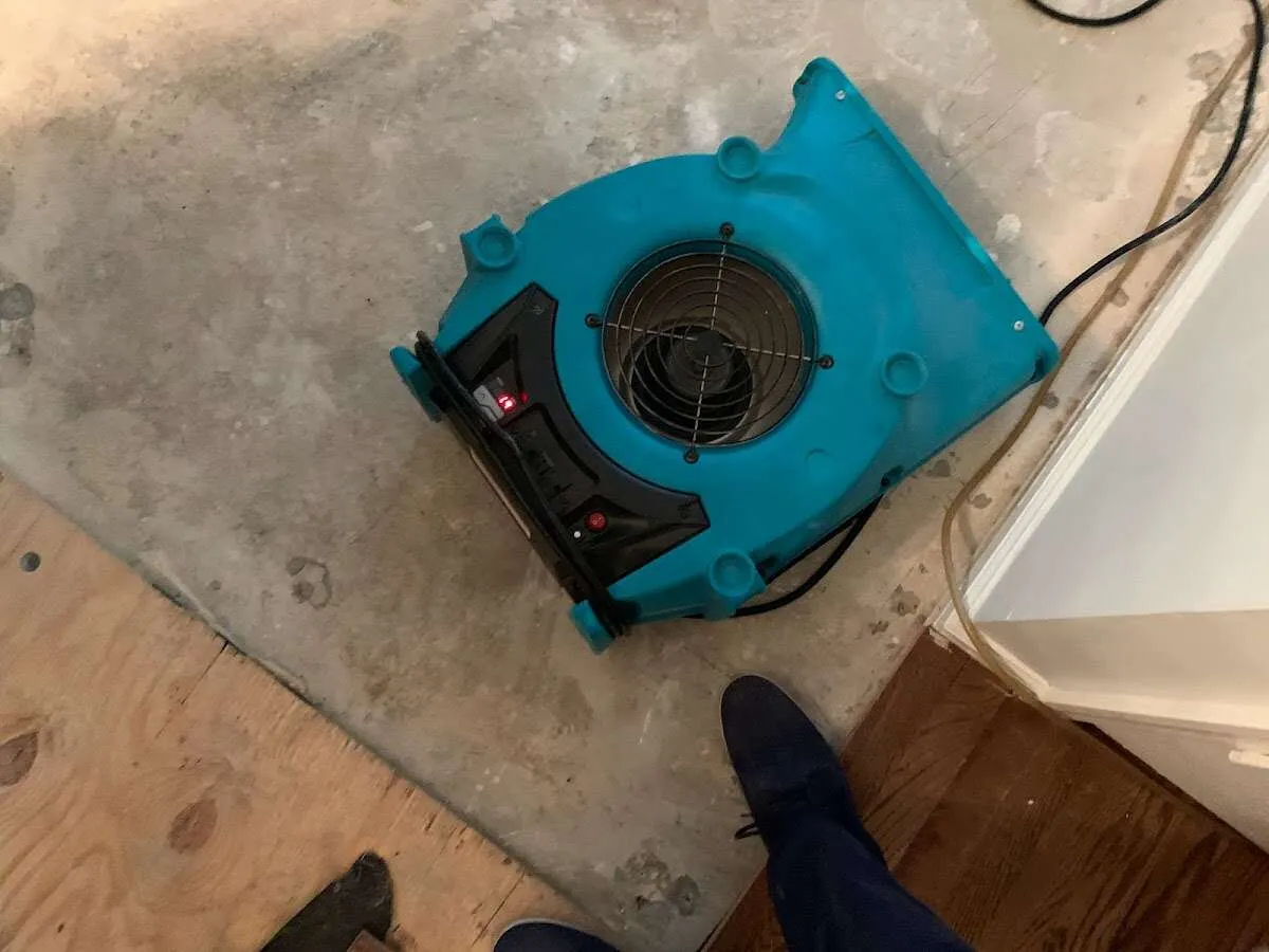 Air mover drying subfloor during Leak Detection & Repair in Elk City